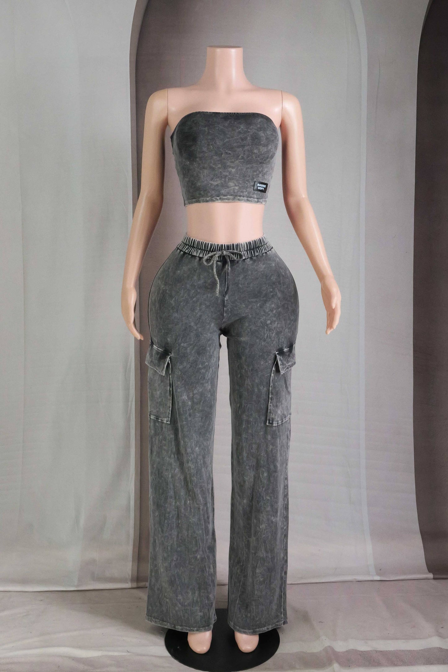 Mannequin wearing a gray strapless top and cargo pants against a plain background