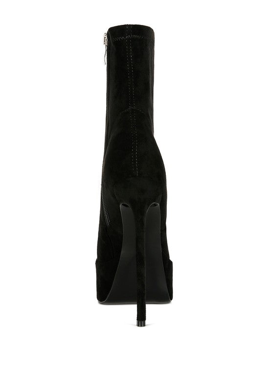 A straight rear view of the black microfiber ankle boot, focusing on the tall, thin stiletto heel and the significant height of the platform base. This boot is available from CO-Wear in Denver, Colorado USA.