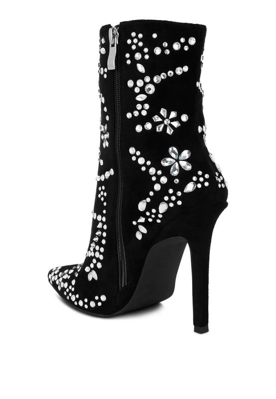 A rear three-quarter view of a black microfiber ankle boot, featuring a high stiletto heel, a pointed toe, a side zipper, and an intricate, floral-inspired pattern of diamante embellishments. Available from CO-Wear in Denver, Colorado USA.