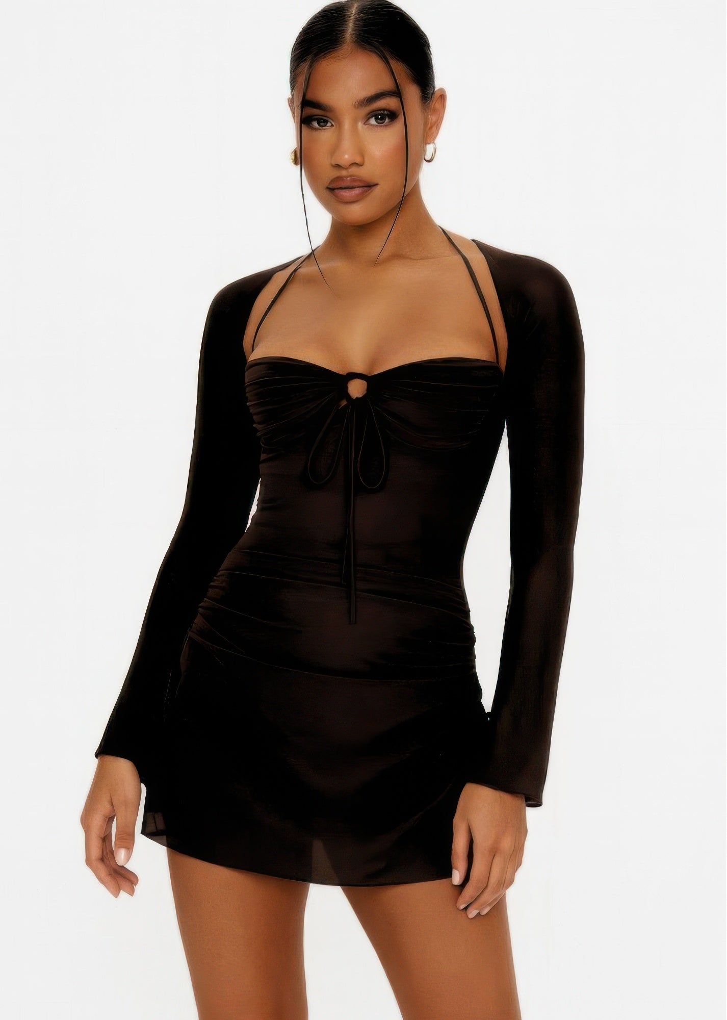 Model wearing a black long-sleeve mini dress featuring a sweetheart neckline, peek-hole cutout with ties, and a halter neck strap. Denver, Colorado USA.