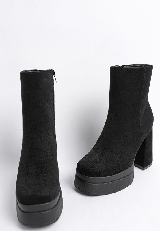 A pair of black microfiber ankle boots with tall shafts, featuring a thick platform sole and a substantial, covered block heel. The boots have a square toe. Available from CO-Wear in Denver, Colorado USA.
