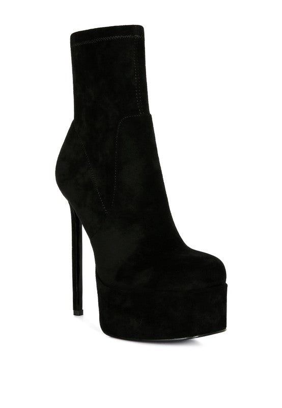 A side profile of a black microfiber ankle boot featuring an extremely high stiletto heel and a thick platform sole. The boot has a clean, seamless, pull-on design. Available from CO-Wear in Denver, Colorado USA.