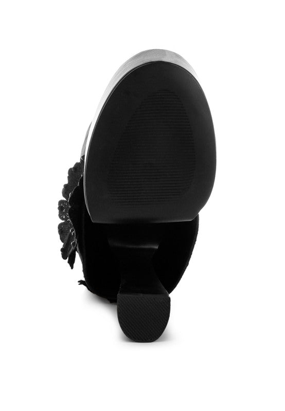 A bottom view of the black 'Sundra' platform boot, showing the dark, textured, non-slip sole and the base of the chunky block heel. Available from CO-Wear in Denver, Colorado USA.