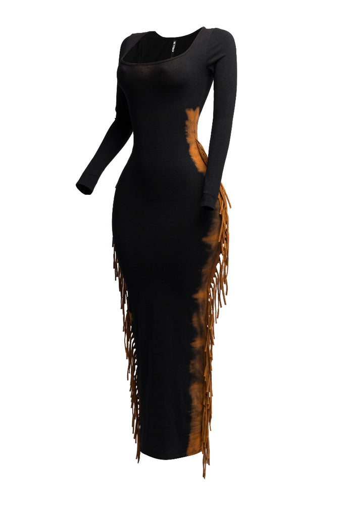 
                  
                    A black long-sleeved bodycon maxi dress with a square neckline is displayed on a mannequin, angled to show the side profile. The dress features brown, distressed-look fringe detailing running down both sides from the hip to the hem. The background is white.
                  
                