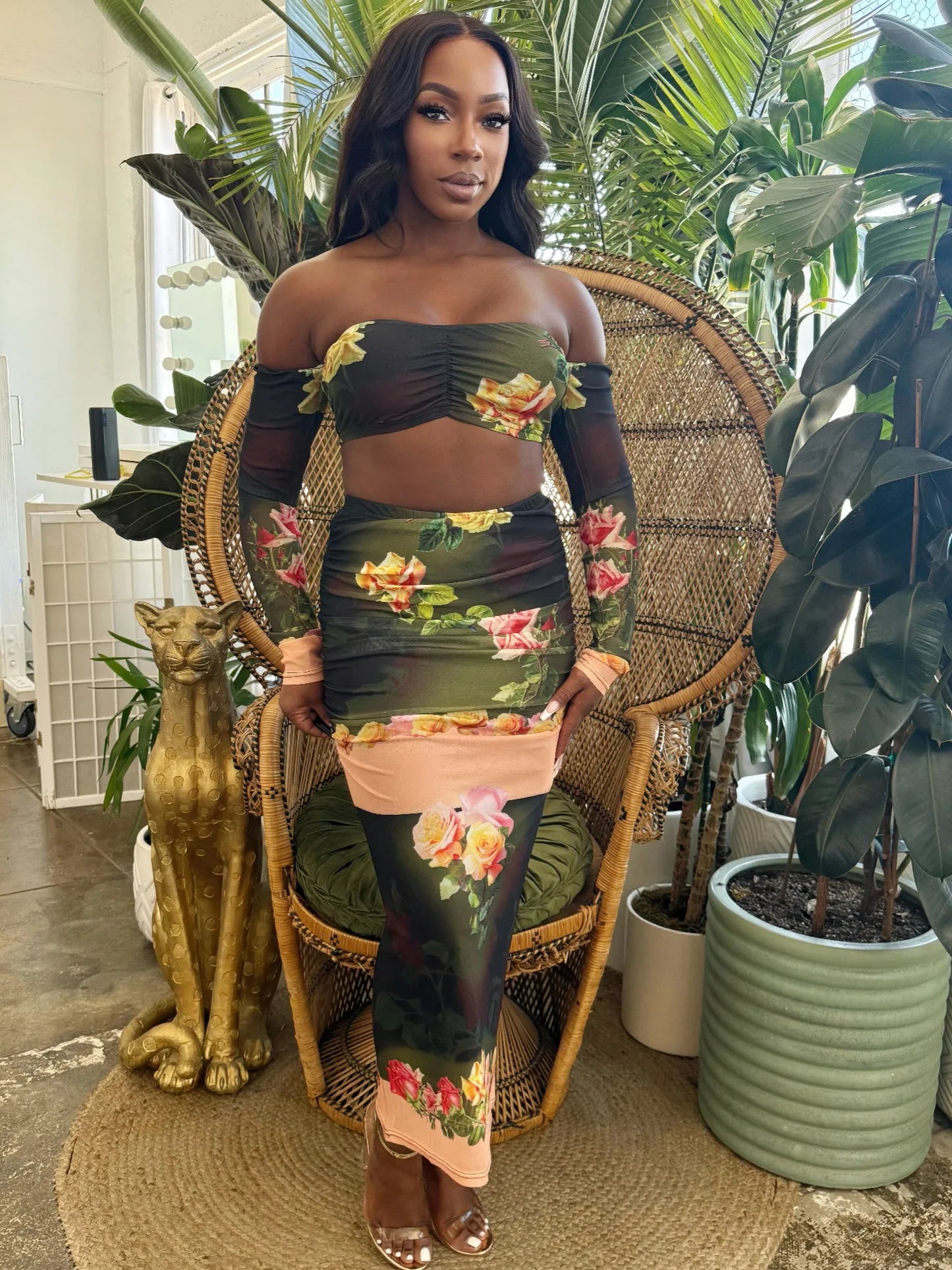 Model in the Eden Rose Mesh Set, featuring a sheer off-shoulder crop top and matching long ruched skirt with a dark floral print. Denver, Colorado USA.