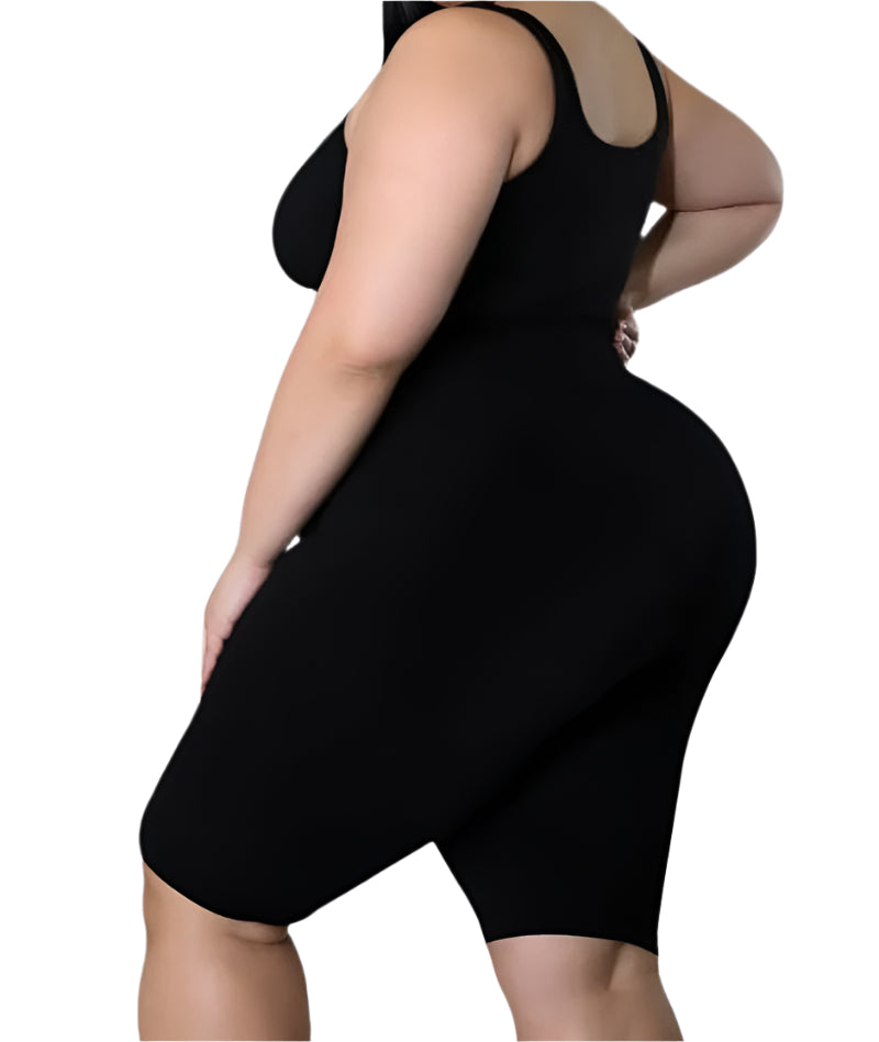 
                  
                    A black, form-fitting, sleeveless stretch romper with shorts is shown. The model is standing with her left hand on her hip, showcasing the garment's silhouette. The background is white.
                  
                