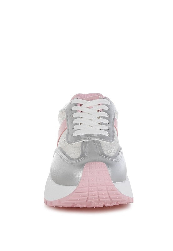 A straight-on front view of the chunky sneaker, highlighting the metallic silver toe cap, white laces, and the prominent pink and white platform sole. Available from CO-Wear in Denver, Colorado USA.