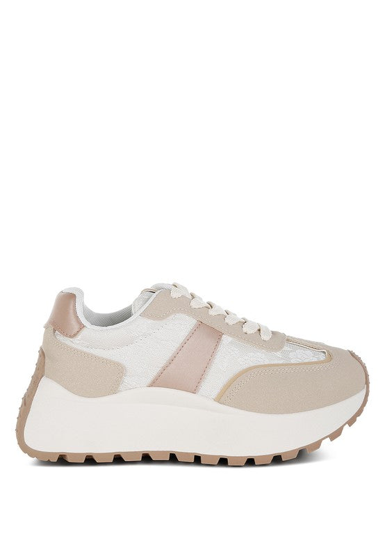 A full side profile view of the beige and neutral 'Squeaker' chunky lace-up sneaker, showing the exaggerated thick anti-skid sole, the beige suede overlay, and the light-colored upper with metallic accents. Available from CO-Wear in Denver, Colorado USA.