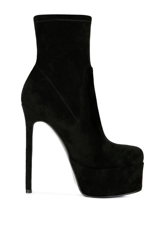 A side profile of a black microfiber ankle boot, showcasing the extreme height of the stiletto heel and the thick platform under the toe. The boot has a sleek finish. Available from CO-Wear in Denver, Colorado USA.