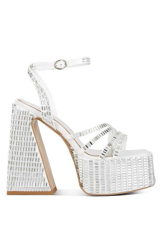 A side profile of the white platform sandal, emphasizing the high, flared block heel and thick platform, both covered in square mirror embellishments. Features an ankle strap closure. Available from CO-Wear in Denver, Colorado USA.