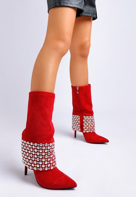 A model's legs wearing bright red suede stiletto boots, styled with the cuff folded down to expose rows of iridescent diamante studs, a side zipper, and a pointed toe. Available from CO-Wear in Denver, Colorado USA.