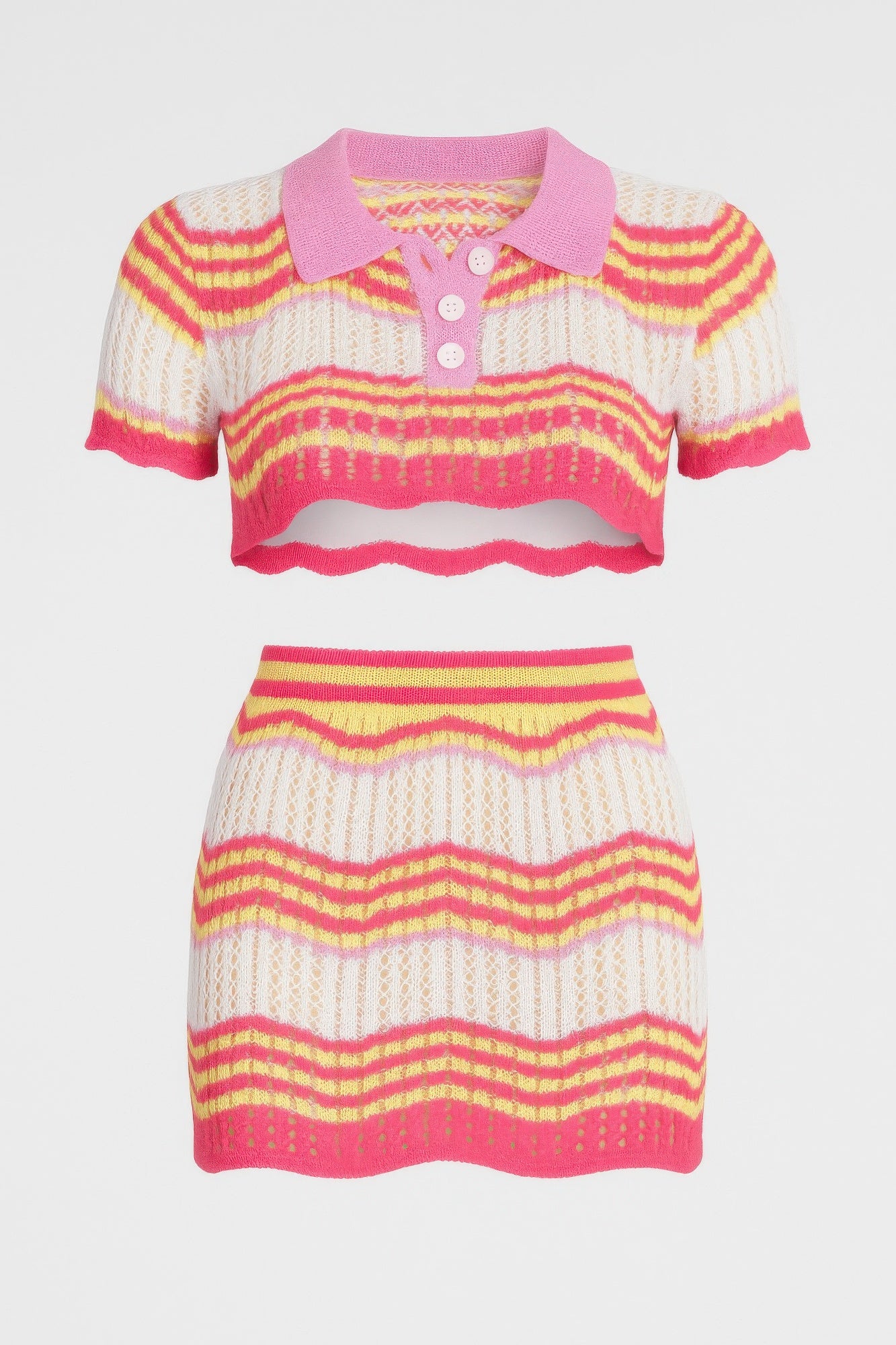 Studio product shot of the pink and yellow Zig Zag Crochet Two Piece Set, featuring a short-sleeve polo crop top and a matching fitted mini skirt. Denver, Colorado USA.