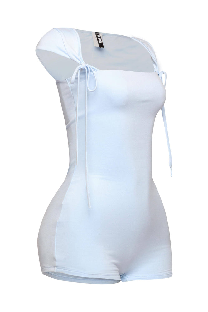 
                  
                    A light-colored short romper is displayed on a mannequin, viewed from a slight side angle. It features a square neckline and short sleeves with tie details at the shoulders. The romper is fitted and designed to hug the body. The background is white.
                  
                