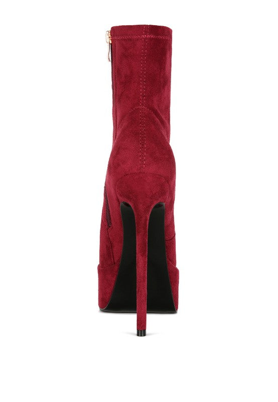 A straight rear view of the red microfiber ankle boot, focusing entirely on the tall, thin stiletto heel and the deep red microfiber material. This boot is available from CO-Wear in Denver, Colorado USA.