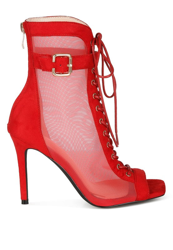 A side view of the red mesh and microfiber stiletto bootie, showing the high stiletto heel, the open peep toe, the ankle strap with a gold buckle, the lace-up front, and the rear zipper closure. Available from CO-Wear in Denver, Colorado USA.