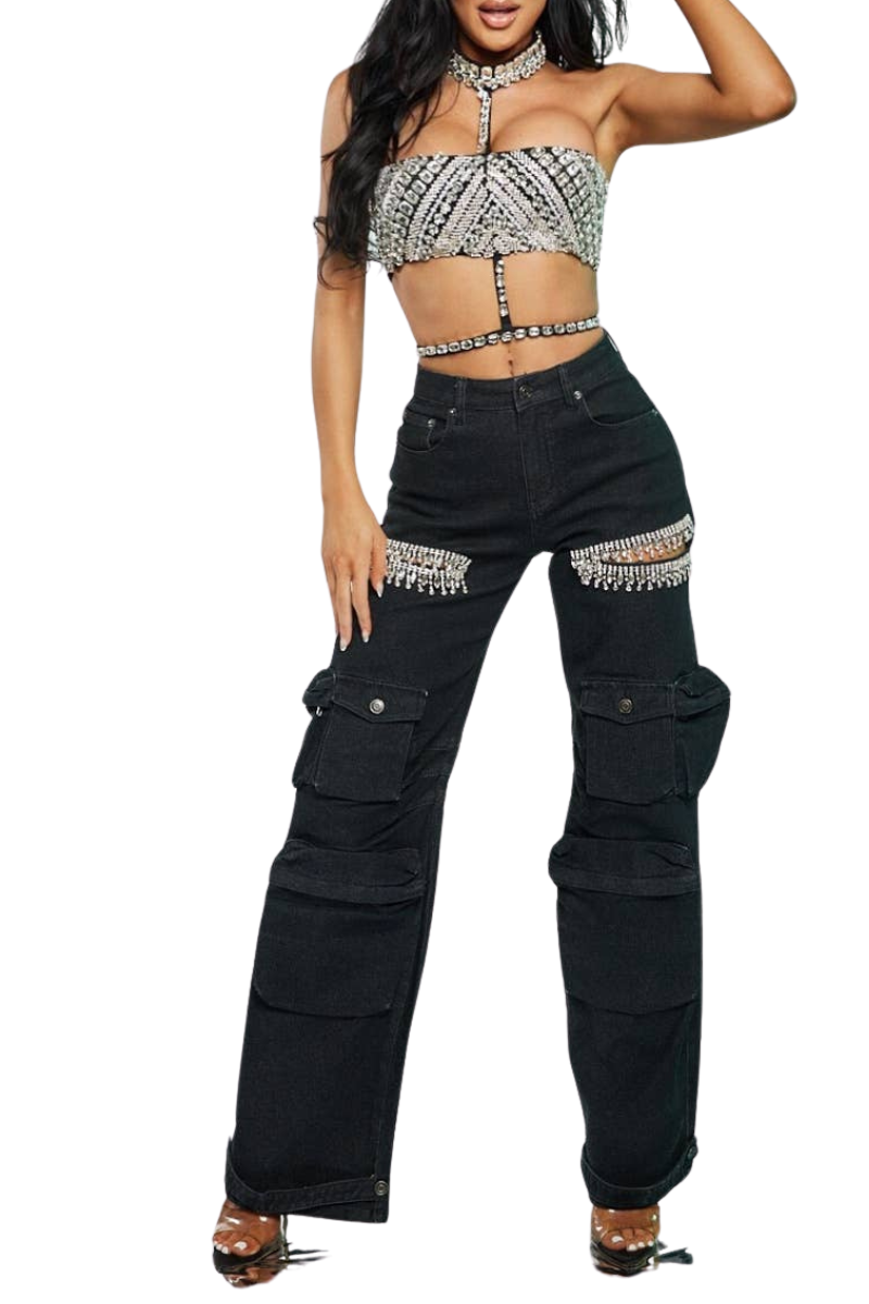 Black cargo pants with silver embellishments worn by a model on a white background