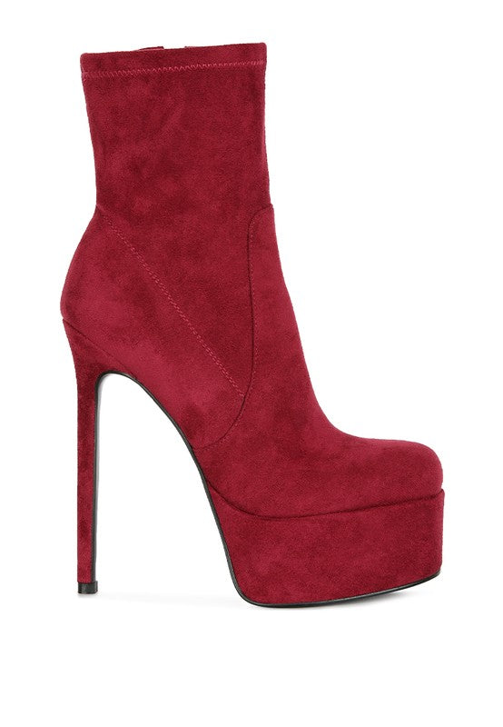 A side profile of a vivid red microfiber ankle boot, showcasing the extreme stiletto heel height and the thick, covered platform sole for clubbing wear. Available from CO-Wear in Denver, Colorado USA.