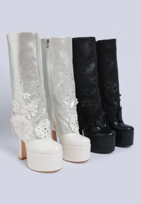 A product line-up of two pairs of white/silver sparkling 'Sundra' platform boots with white floral appliques and two pairs of black laser-cut floral platform boots. Available from CO-Wear in Denver, Colorado USA.
