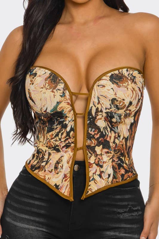 
                  
                    Woman wearing a floral-patterned corset top with a plain background
                  
                