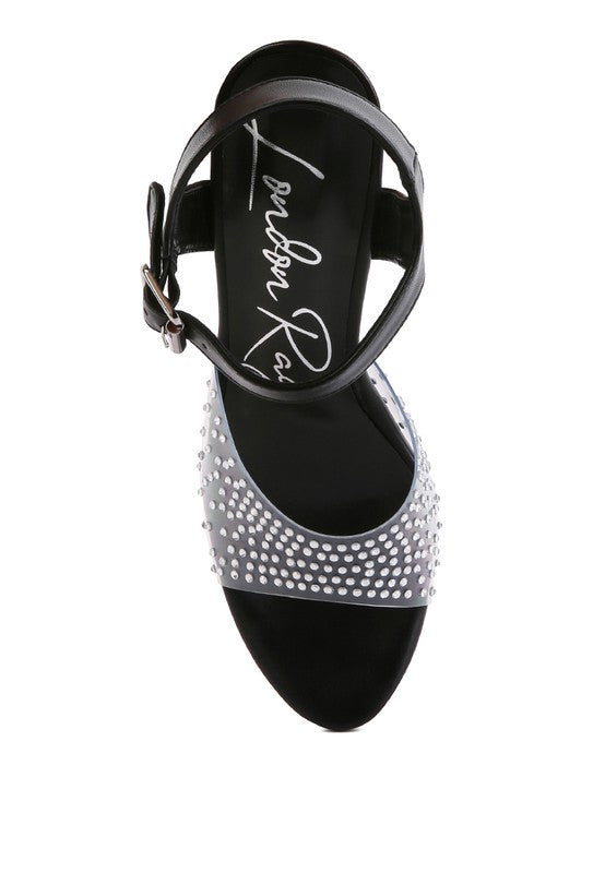 A top-down view of the black 'First Date' sandal, showing the ankle strap, the toe bed's cursive logo, and the clear toe strap studded with rhinestones. Available from CO-Wear in Denver, Colorado USA.
