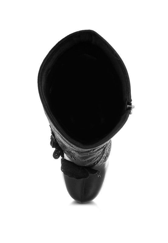 A top-down view of the black 'Sundra' platform boot, showing the inner lining, the zipper pull, and the laser-cut floral applique detail near the ankle. Available from CO-Wear in Denver, Colorado USA.