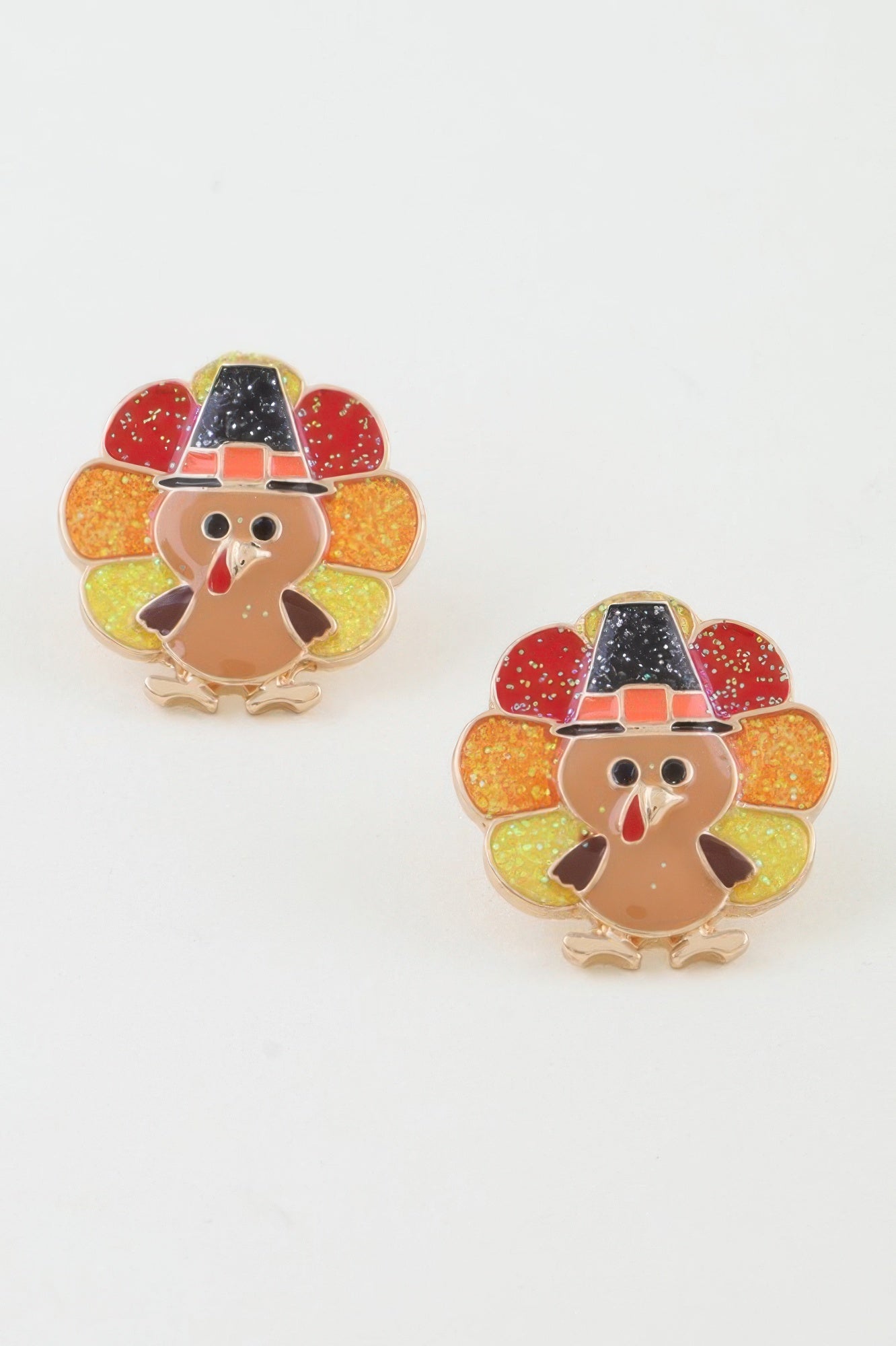 Turkey-shaped earrings with colorful hats on a white background