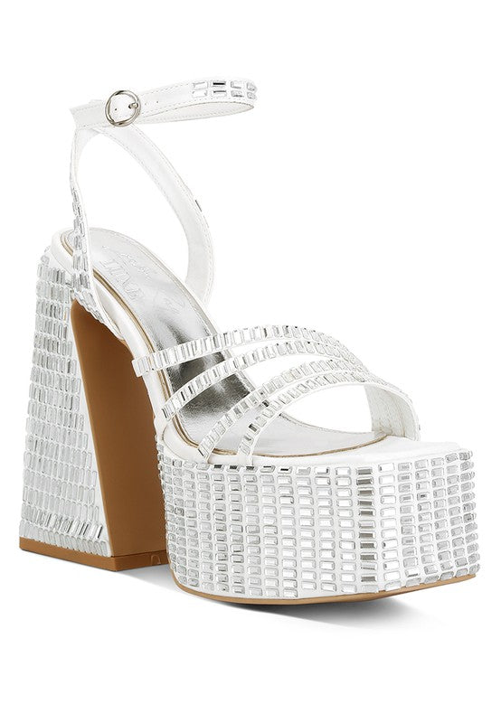A side profile of a white satin platform sandal featuring a thick ankle strap, wide toe straps, and a chunky block heel and platform completely covered in square, mirror-like embellishments. Available from CO-Wear in Denver, Colorado USA.