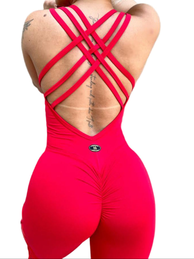 
                  
                    Person wearing a red open-back jumpsuit against a gray concrete wall. Other styles available with our activewear collection.
                  
                