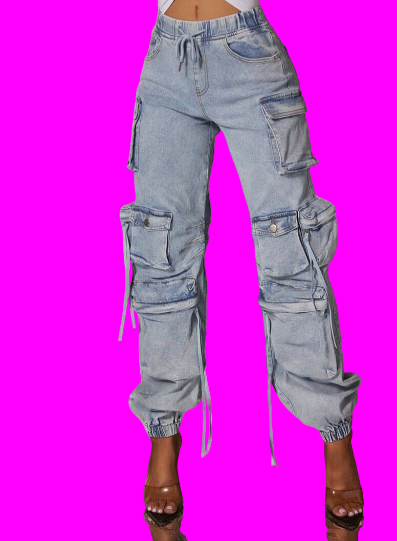 Light blue distressed cargo pants worn by a person on a beige background