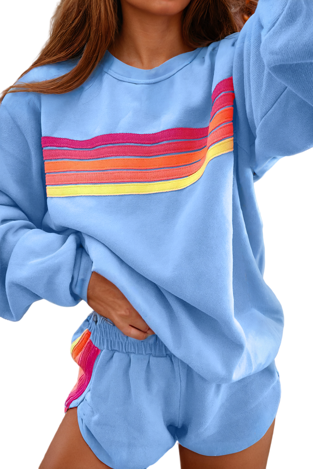 Light blue sweatshirt with colorful stripe design and matching shorts on a white background. comfortable women's loungewear.