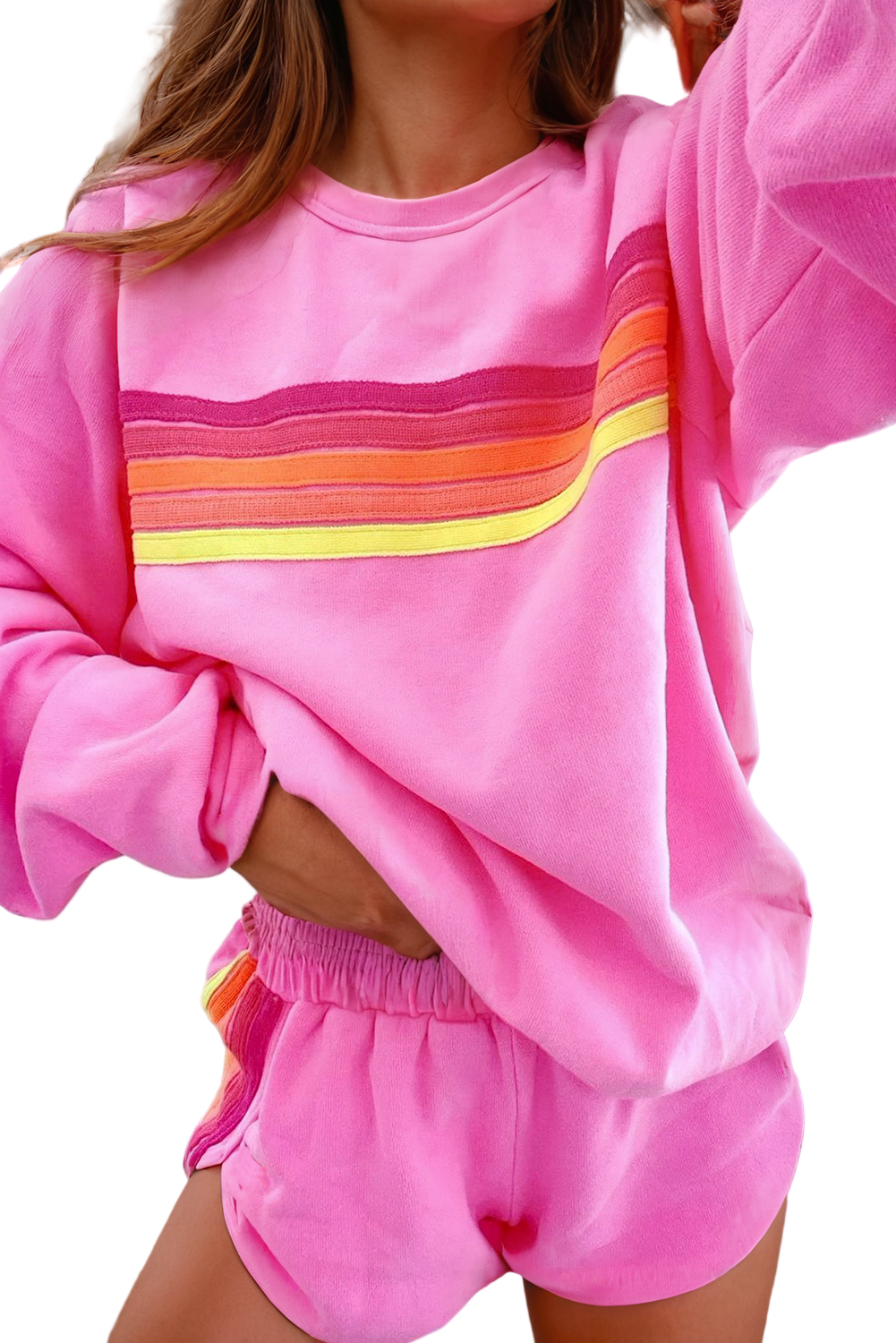 Person wearing a pink outfit with colorful stripes in a casual setting. cozy women's loungewear
