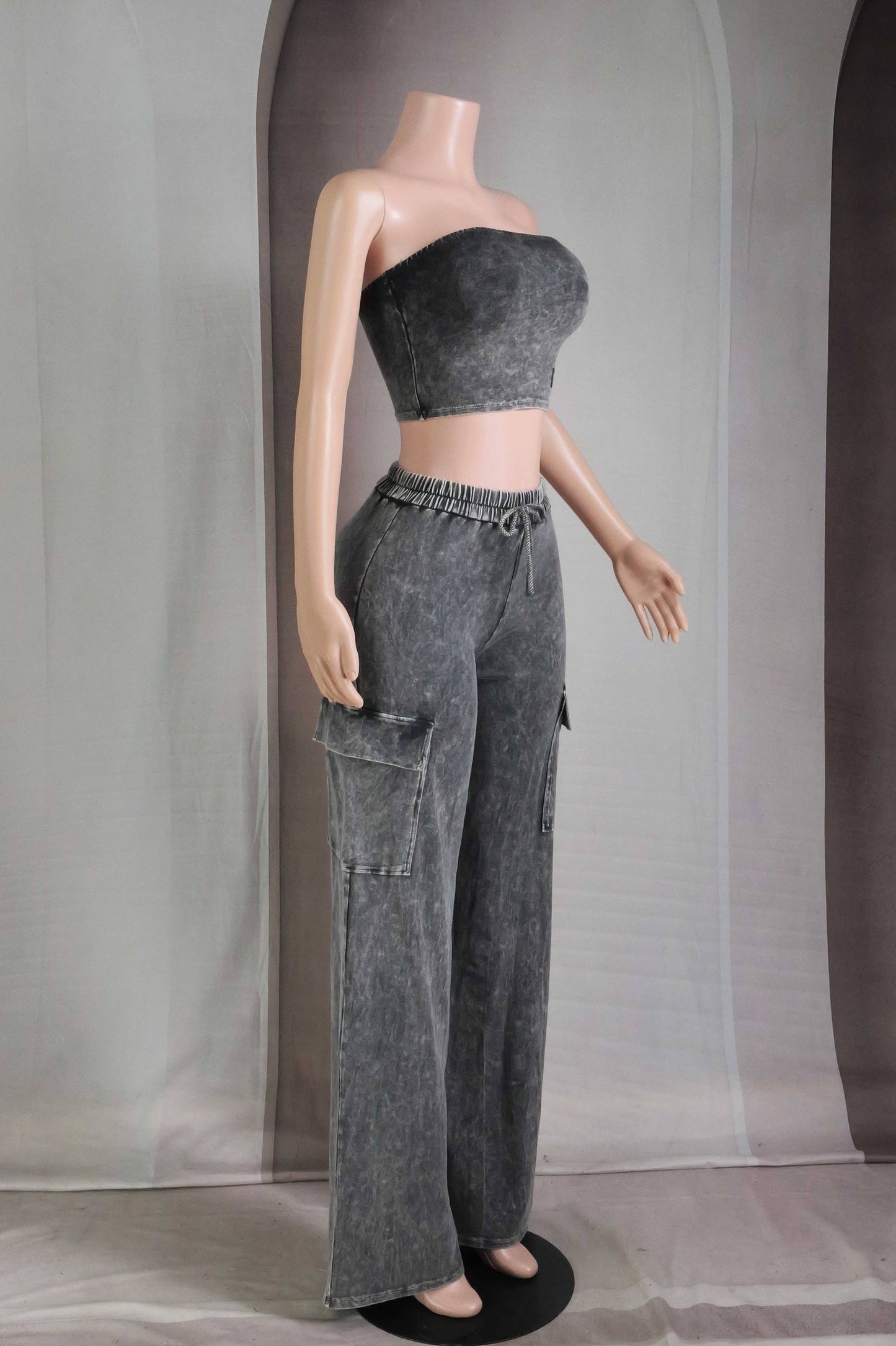 Mannequin wearing a gray strapless top and cargo pants against a plain background