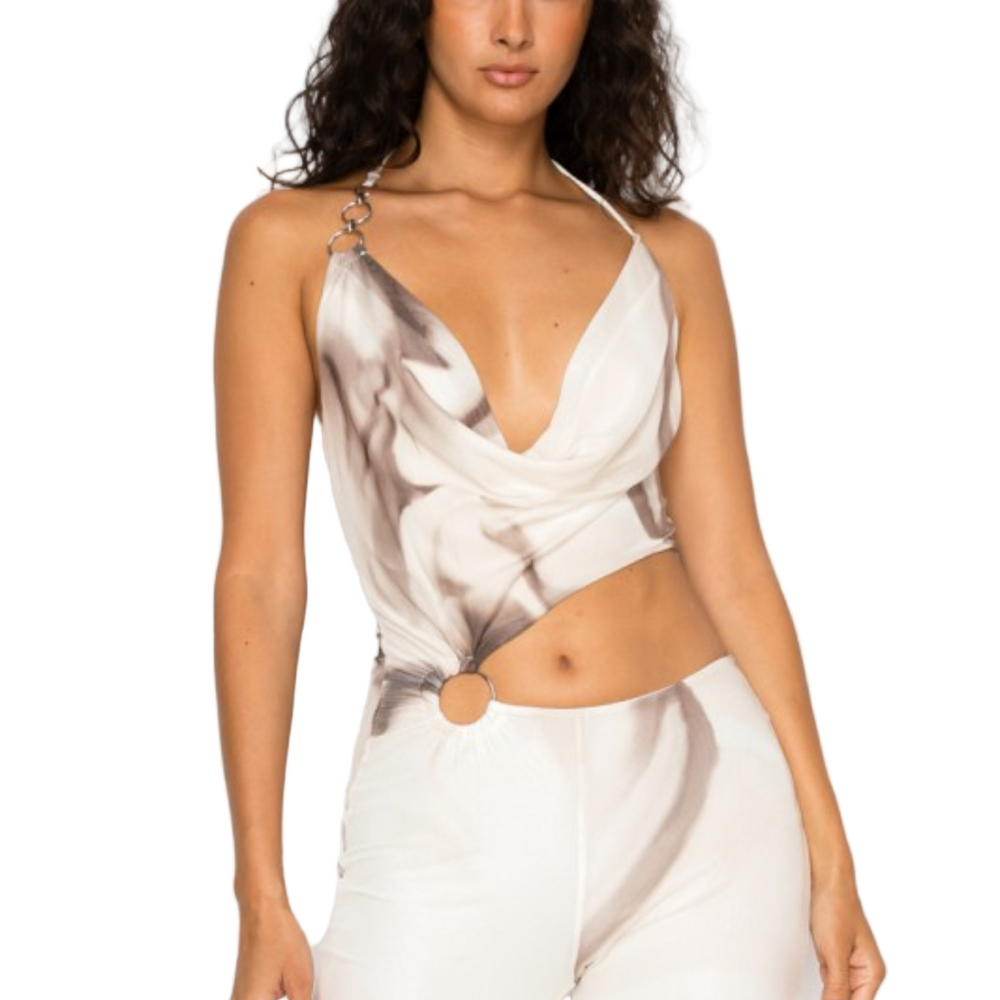 
                  
                    Woman wearing a white abstract print jumpsuit on a clothing website.
                  
                
