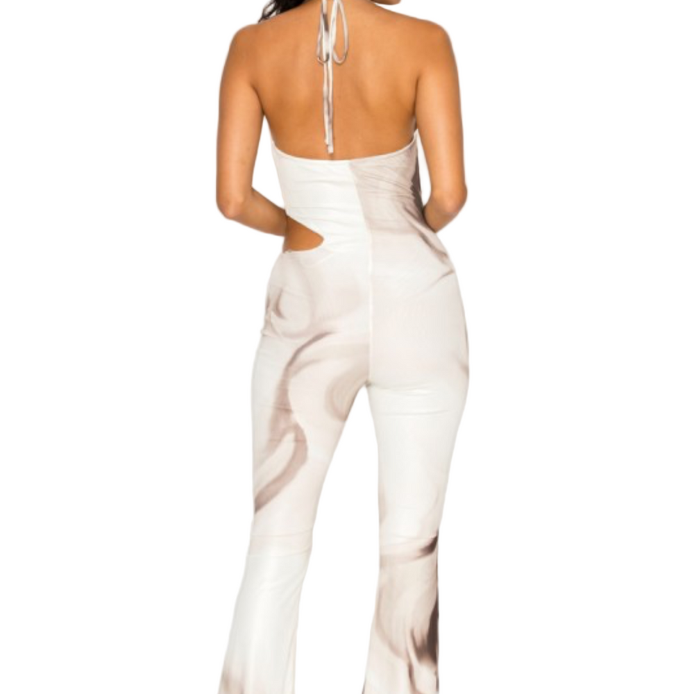 Woman wearing a white abstract patterned jumpsuit with a back view on a white background.