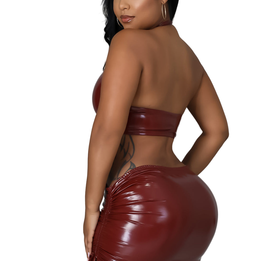
                  
                    Woman wearing a shiny red outfit against a gray background
                  
                