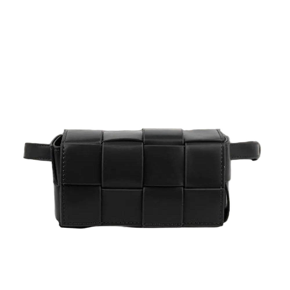 Black woven belt bag on a reflective surface with a neutral background