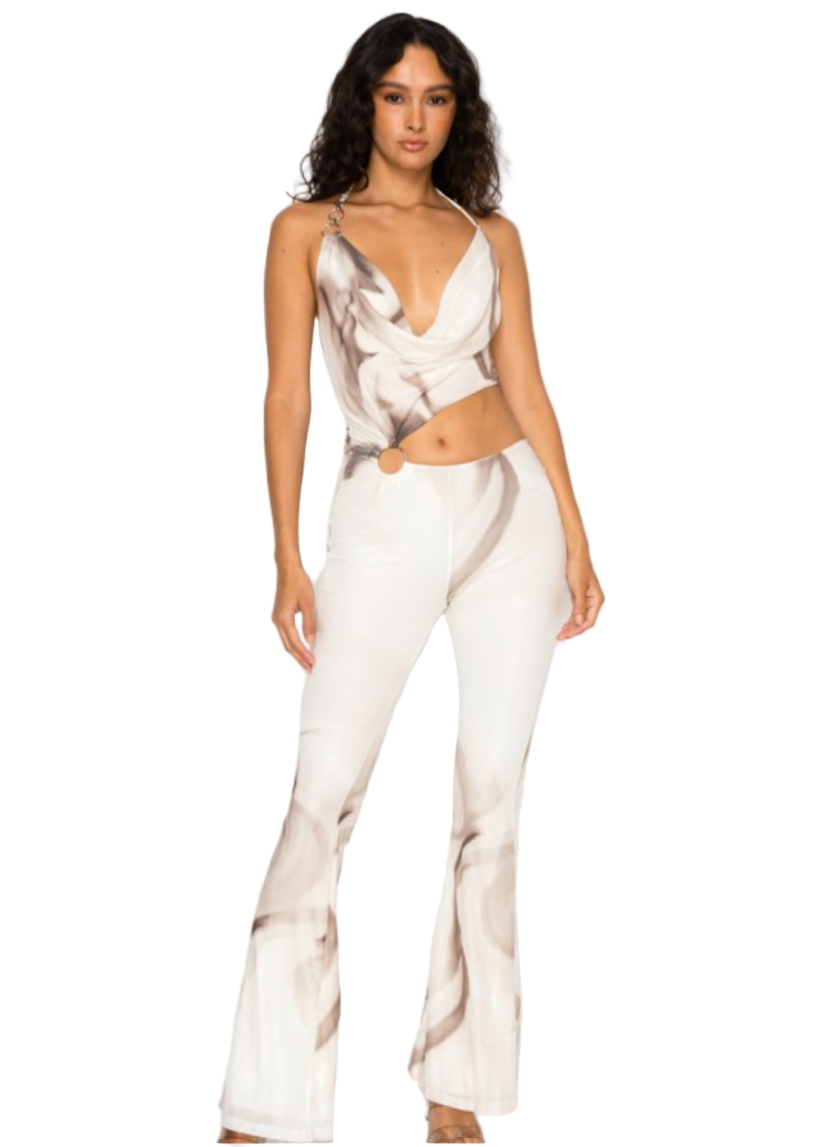 Woman wearing a white abstract print jumpsuit.